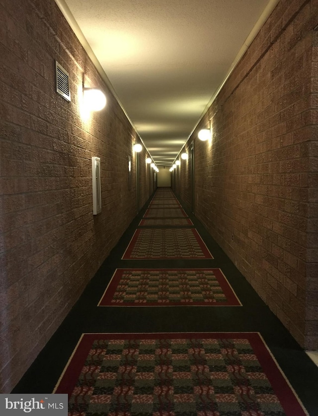 hallway with brick wall