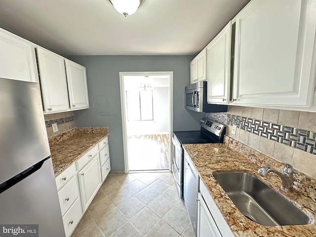 kitchen with sink, white cabinets, and stainless steel appliances