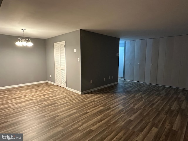 interior space featuring an inviting chandelier and dark hardwood / wood-style flooring