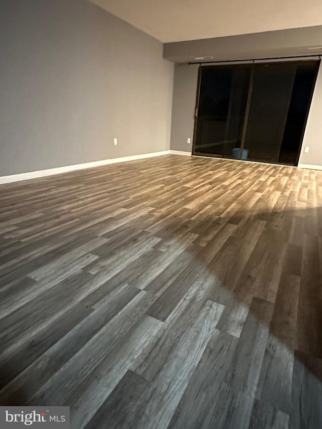 spare room with wood-type flooring