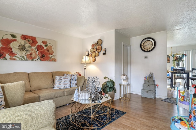 living room featuring hardwood / wood-style flooring and a textured ceiling