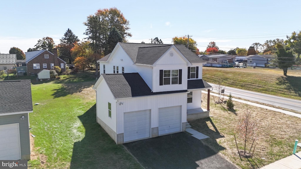 exterior space featuring a lawn and a garage