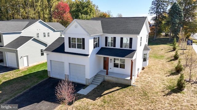 view of front of house featuring a garage and a front lawn