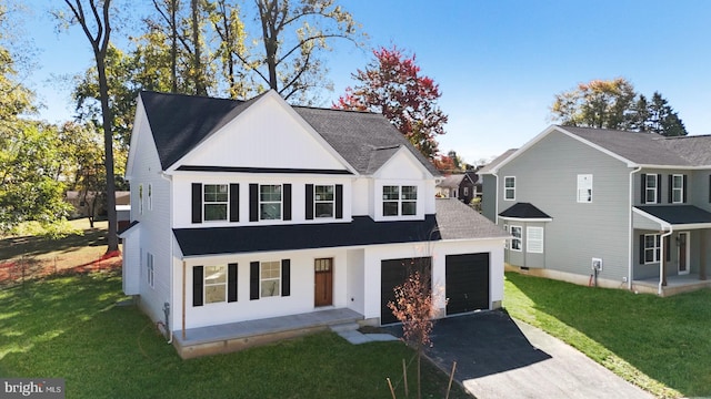 view of front of house featuring a garage and a front yard