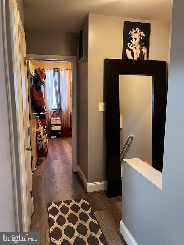 hallway featuring dark hardwood / wood-style flooring