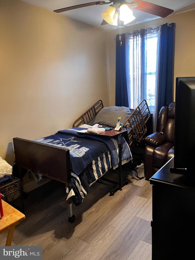 bedroom with hardwood / wood-style flooring and ceiling fan