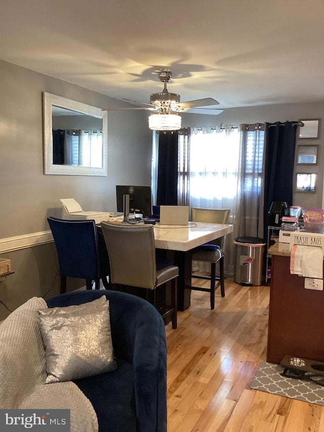 dining room with hardwood / wood-style floors and ceiling fan