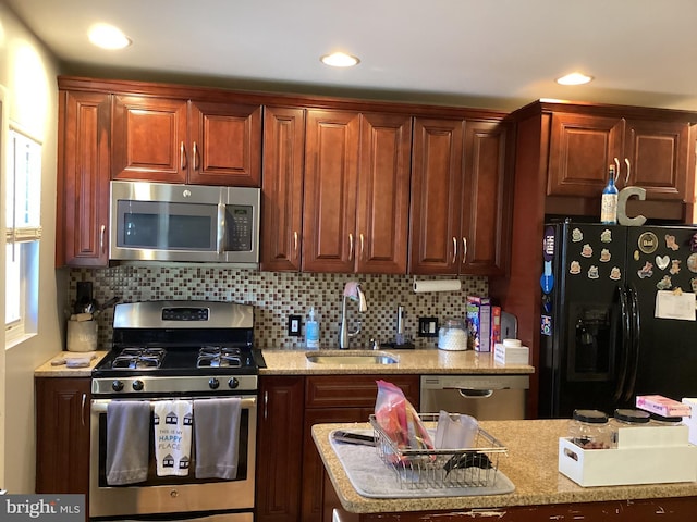5437 Force Rd, Baltimore, MD 21206 - kitchen featuring stainless steel appliances, a sink, tasteful backsplash, and recessed lighting