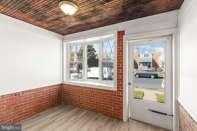 unfurnished sunroom featuring wood ceiling and a healthy amount of sunlight