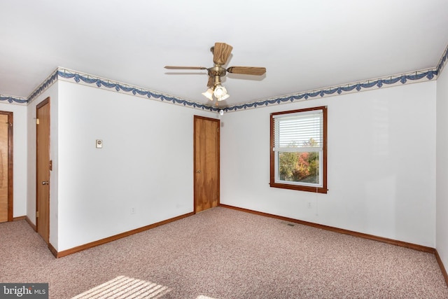 carpeted empty room featuring ceiling fan