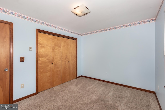 unfurnished bedroom featuring a closet and carpet floors