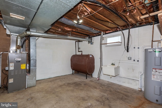 basement featuring water heater, sink, and heating unit