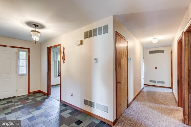 view of carpeted foyer entrance