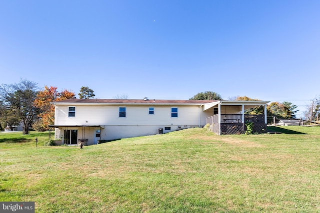 back of property featuring a lawn