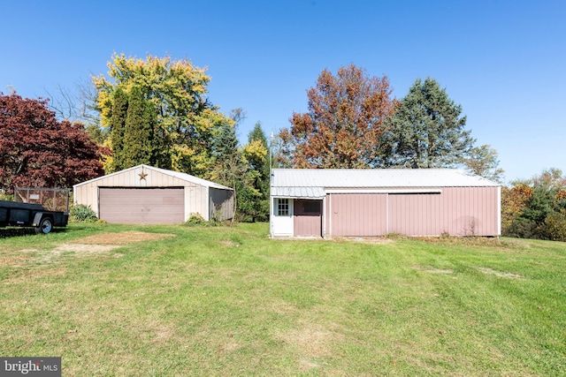 view of outbuilding featuring a yard and a garage