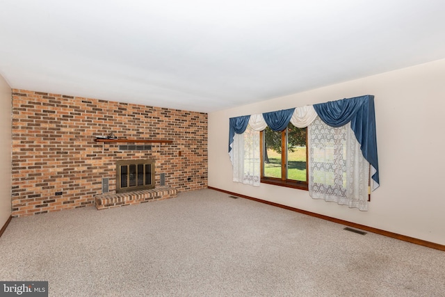 unfurnished living room featuring brick wall, carpet floors, and a fireplace