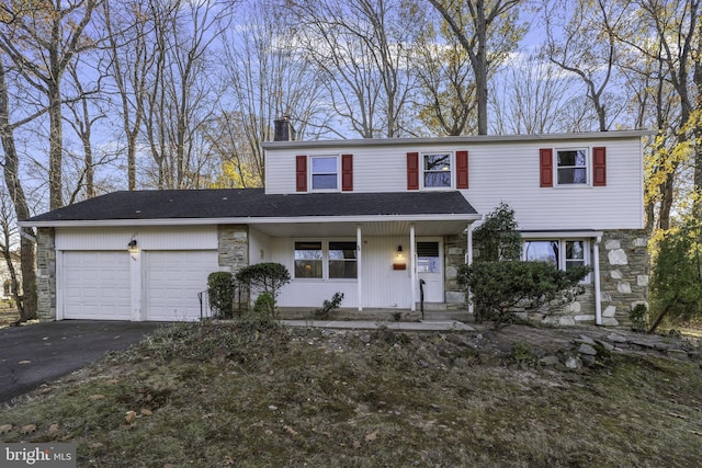 front of property with a porch and a garage