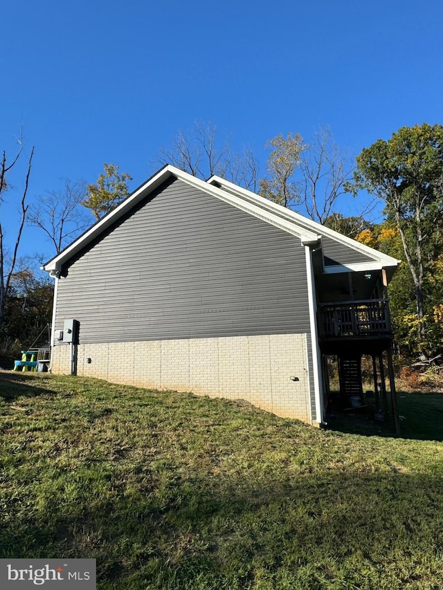 view of home's exterior with a yard and a deck