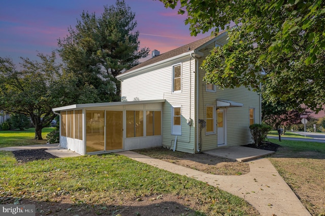 exterior space with a yard and a sunroom