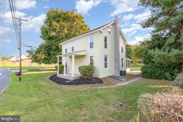 view of home's exterior featuring a lawn and cooling unit