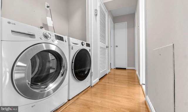 laundry area featuring light hardwood / wood-style flooring and separate washer and dryer