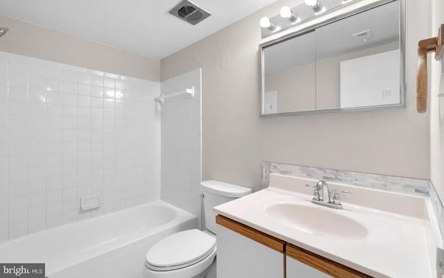 full bathroom with vanity, toilet, and tiled shower / bath