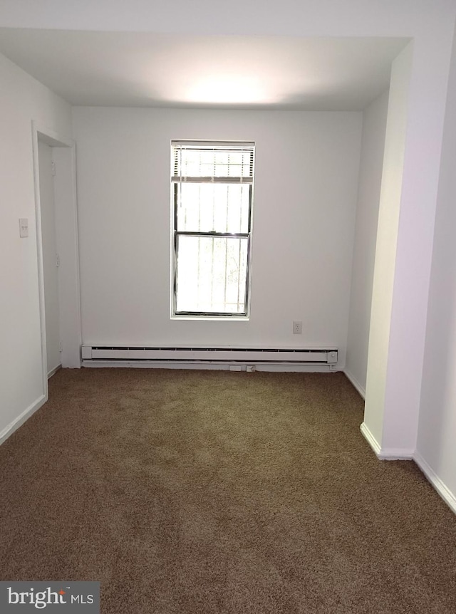 empty room featuring dark colored carpet