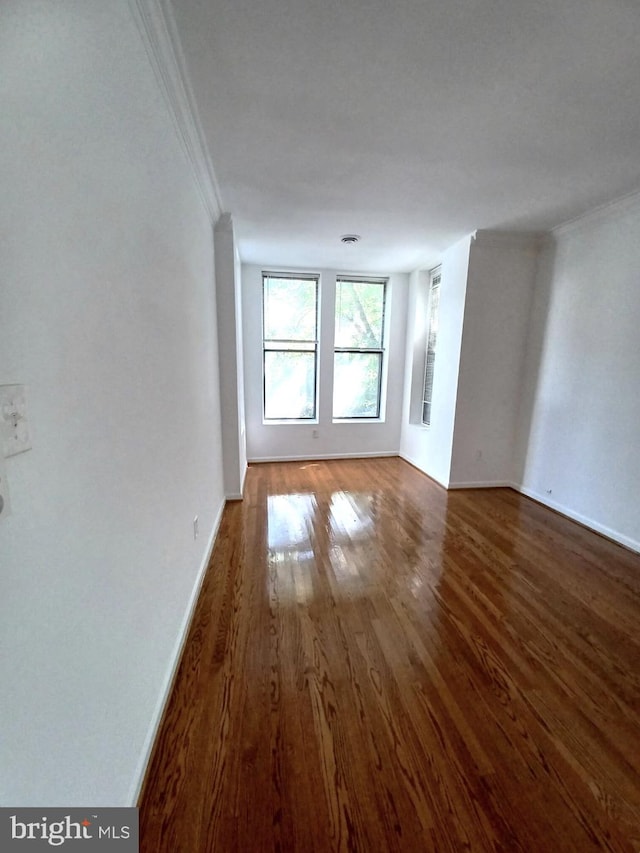 unfurnished room featuring crown molding and dark hardwood / wood-style floors