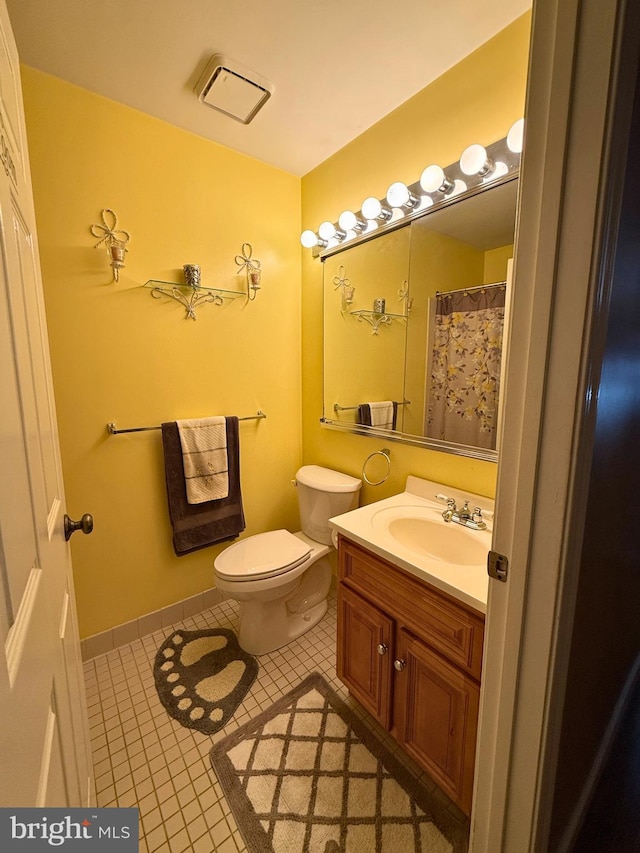 bathroom with tile patterned floors, vanity, and toilet