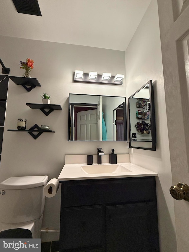 bathroom with vanity and toilet