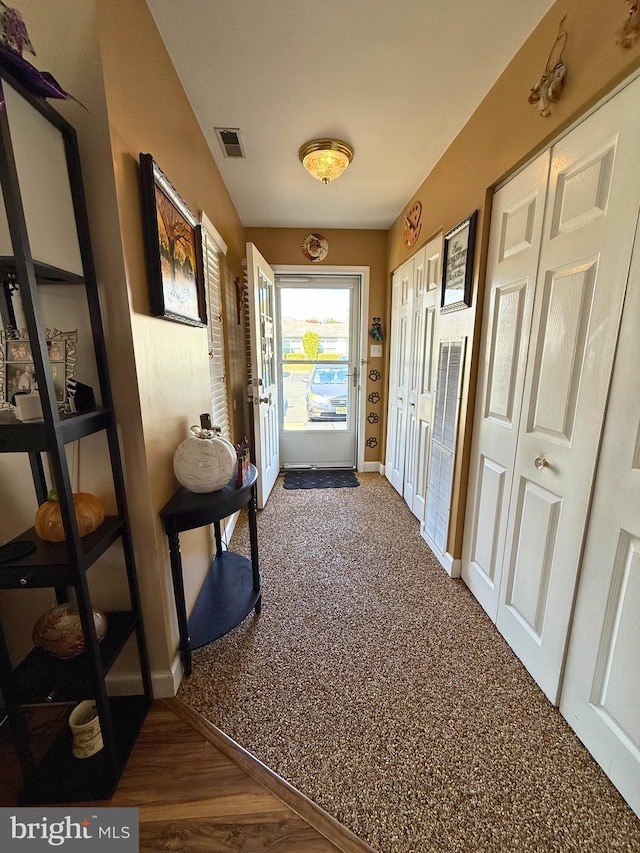 corridor with hardwood / wood-style floors