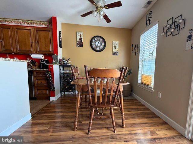 dining area with ceiling fan and dark hardwood / wood-style floors