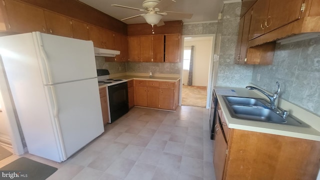 kitchen featuring ceiling fan, sink, and white appliances