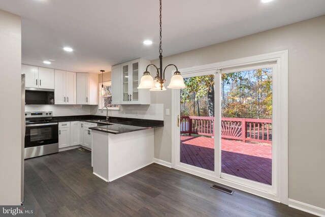 kitchen featuring stainless steel appliances, sink, decorative light fixtures, white cabinets, and dark hardwood / wood-style flooring