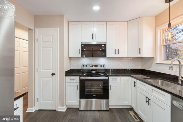 kitchen with pendant lighting, white cabinets, sink, and stainless steel appliances