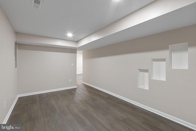 basement featuring dark hardwood / wood-style flooring