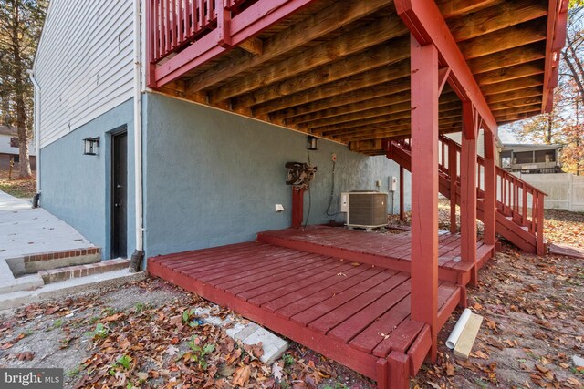 wooden deck featuring cooling unit