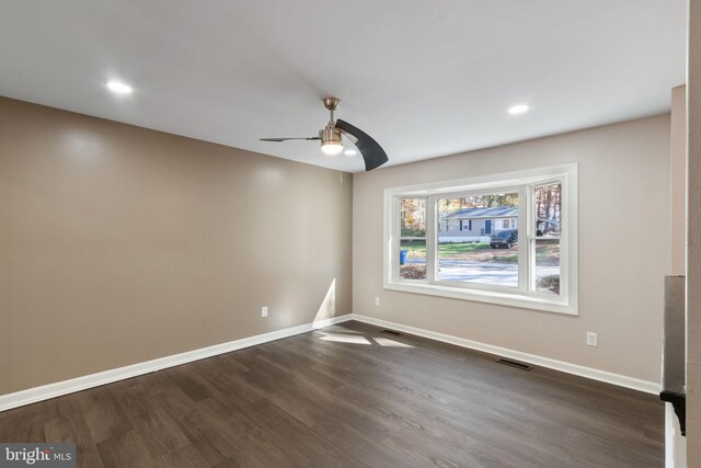 unfurnished room featuring dark hardwood / wood-style floors and ceiling fan