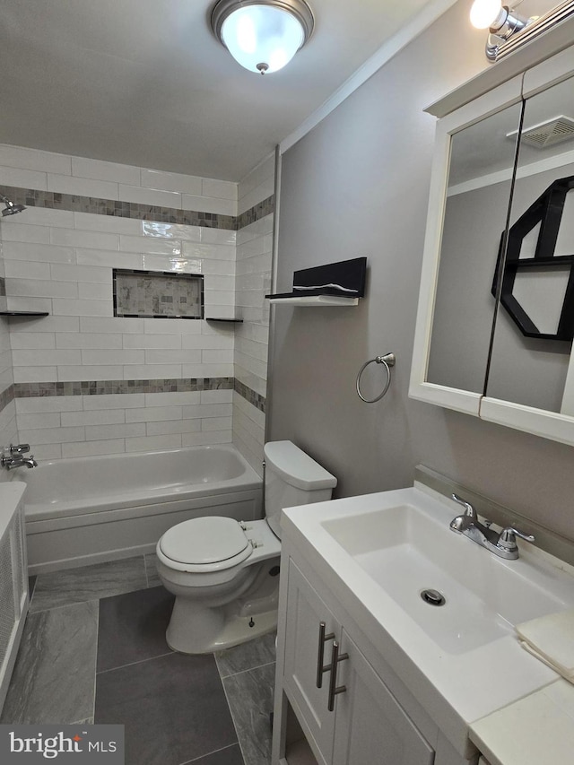 full bathroom featuring toilet, tiled shower / bath, vanity, crown molding, and tile patterned flooring