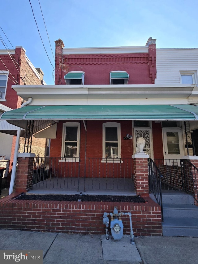 view of property with cooling unit and covered porch