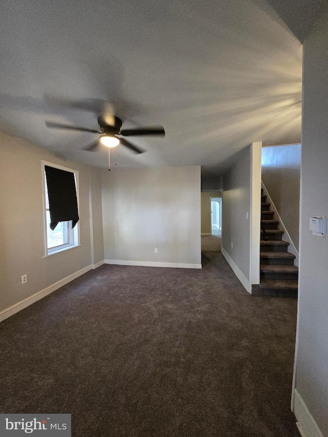 carpeted empty room featuring a textured ceiling and ceiling fan