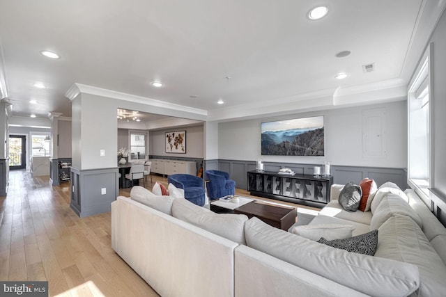 living room featuring light hardwood / wood-style flooring and ornamental molding