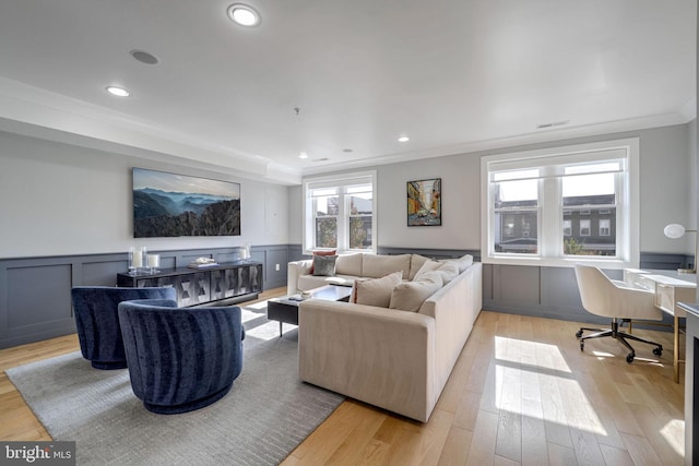 living room featuring light hardwood / wood-style flooring and crown molding