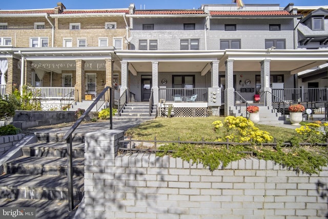 view of property featuring covered porch