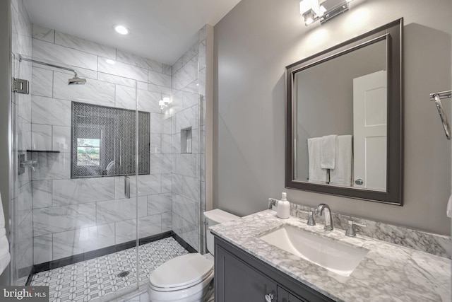 bathroom featuring toilet, walk in shower, and vanity