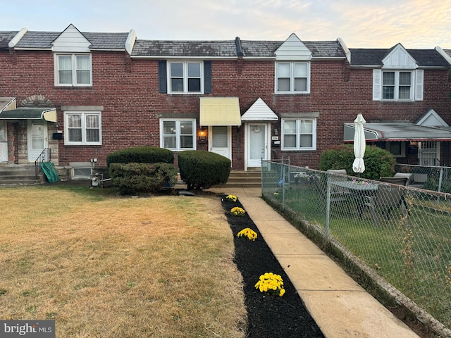 view of property featuring a front lawn