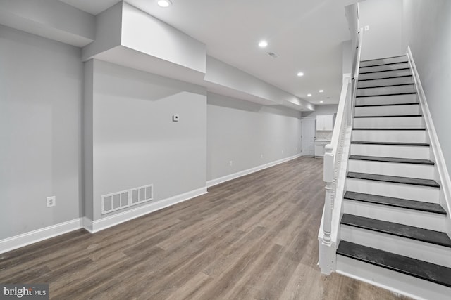 basement with hardwood / wood-style flooring