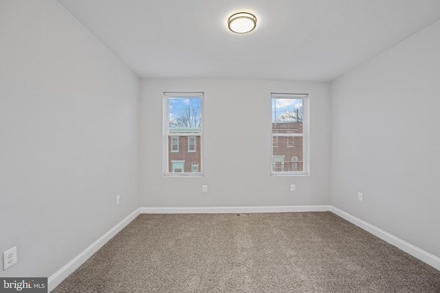 carpeted spare room with plenty of natural light