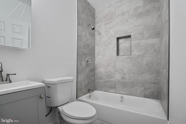 full bathroom with vanity, tiled shower / bath combo, and toilet