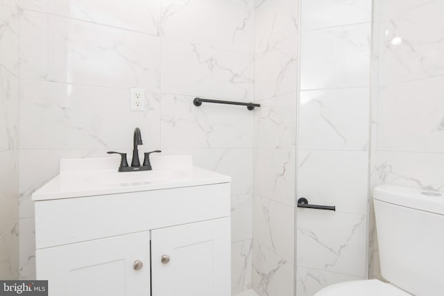 bathroom featuring toilet and vanity